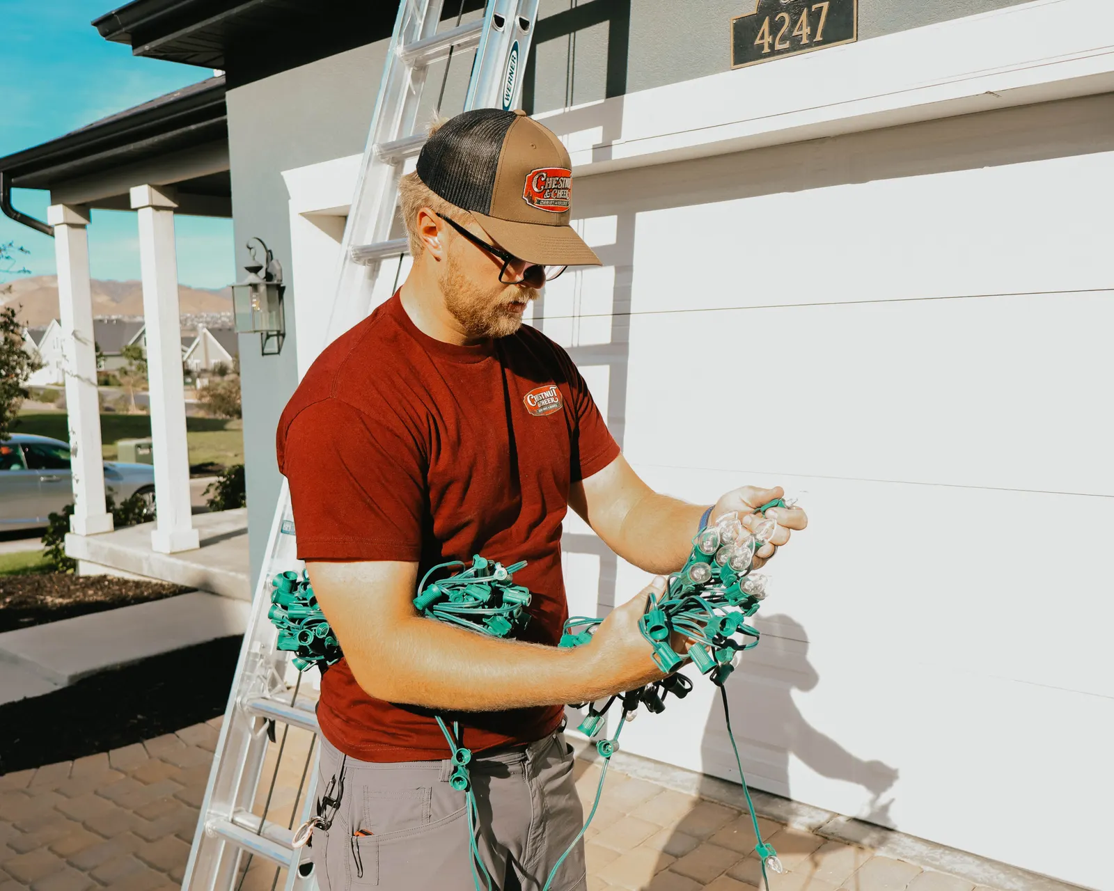 Chestnut & Cheer technician organizing commercial-grade Christmas light strands in Utah